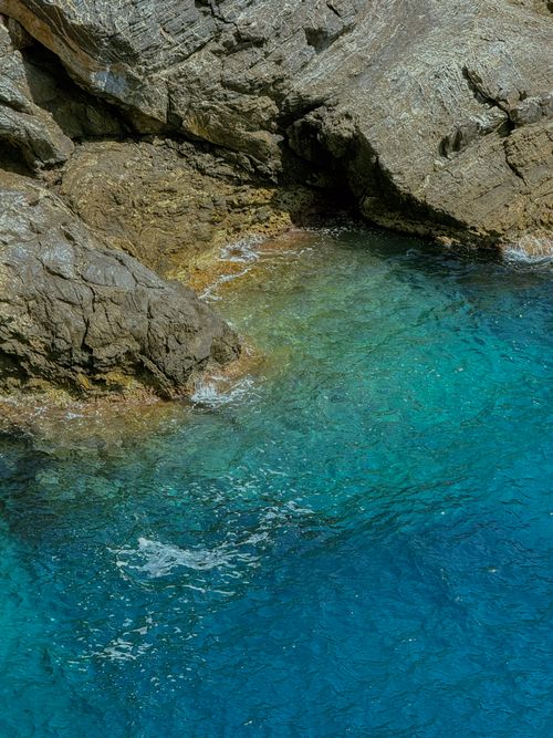 Free Captivating aerial shot of the rocky coastline and turquoise waters in Hyères, France. Stock Photo