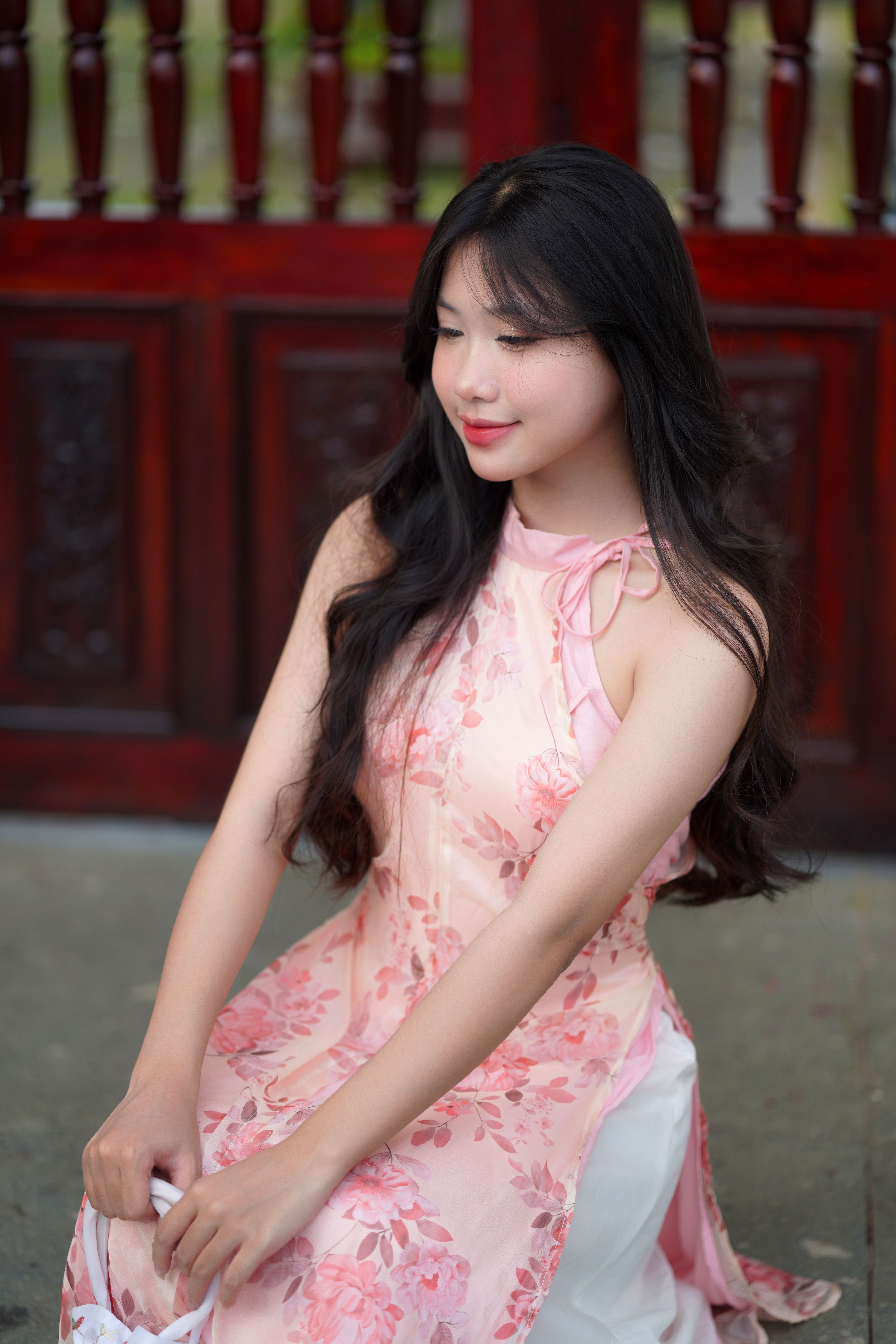 Elegant Woman in Floral Dress Posing Outdoors · Free Stock Photo