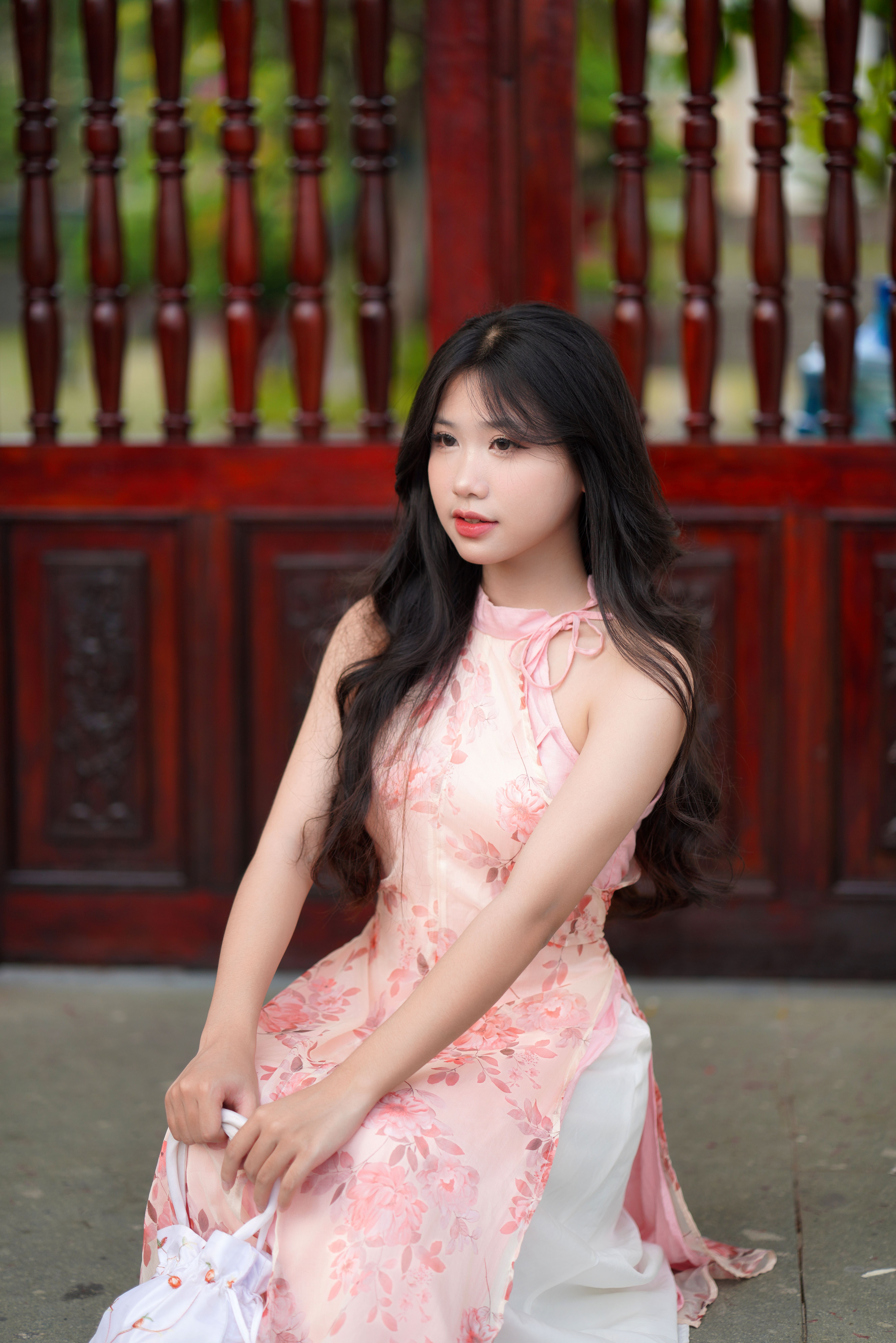 Elegant Woman in Floral Dress Posing Outdoors · Free Stock Photo