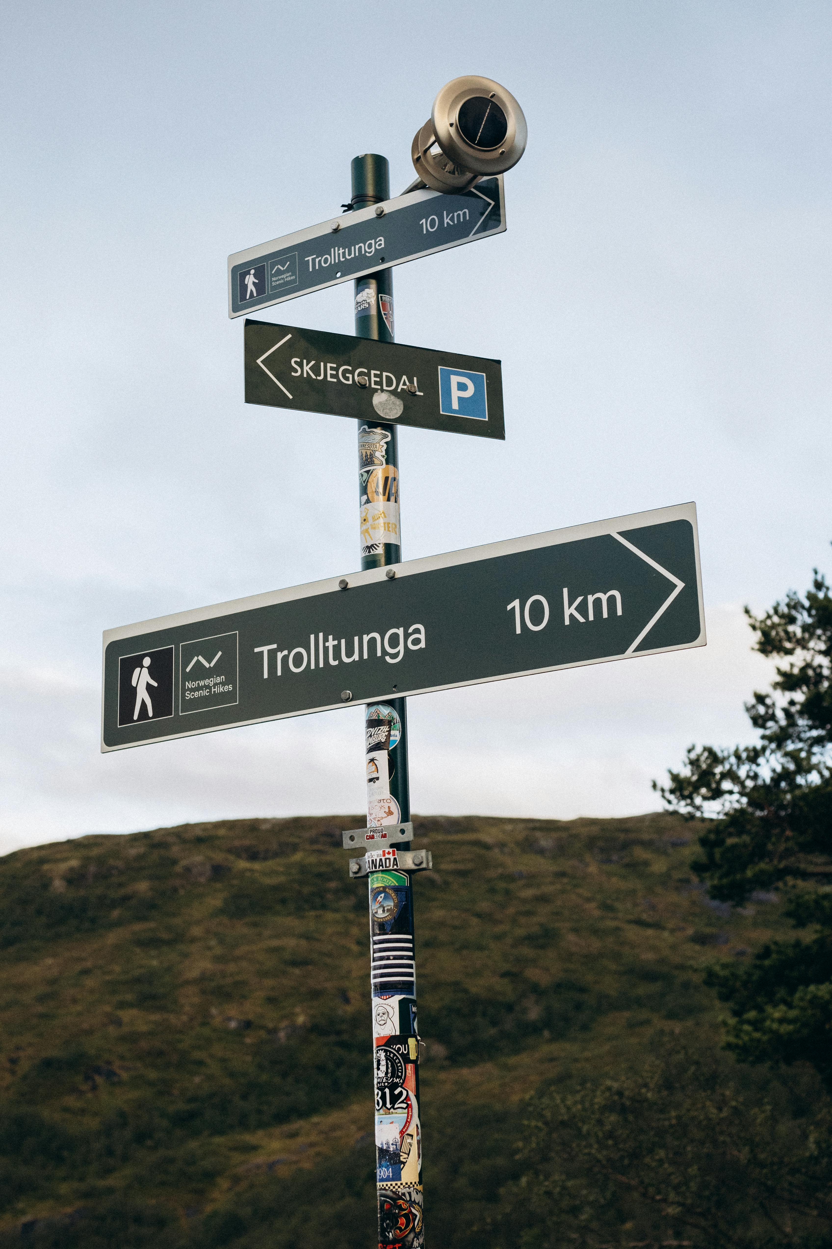 Scenic view of a signpost indicating the trail to Trolltunga in Vestland, Norway.