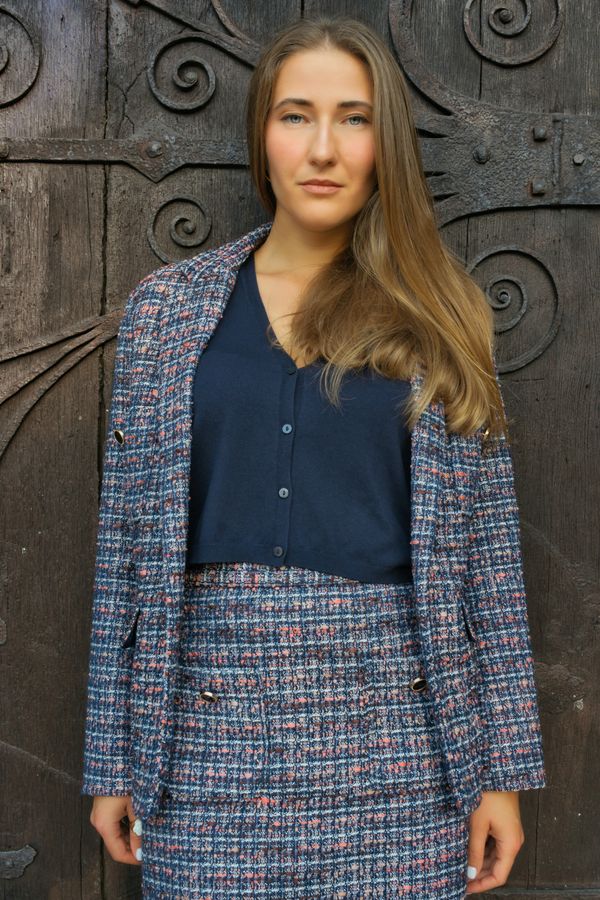 Tweed blazer worn over a simple dress