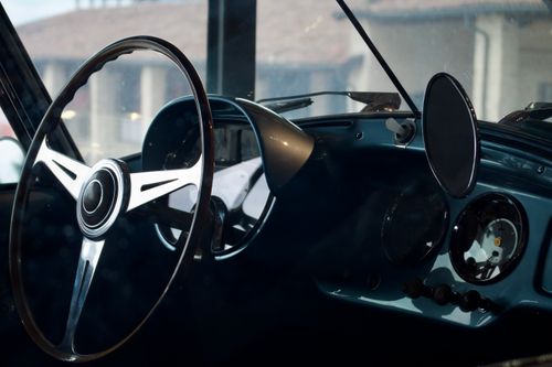 Free Close-up of a vintage car steering wheel and dashboard with a classic design. Stock Photo