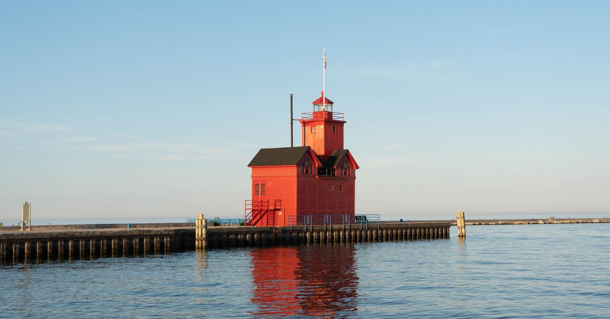 Capture of the vibrant Holland Harbor Lighthouse during a serene summer evening on Lake Michigan.