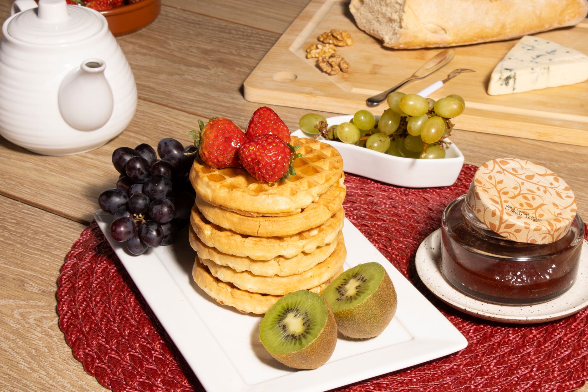 Healthy homemade waffles topped with nuts and fresh fruit