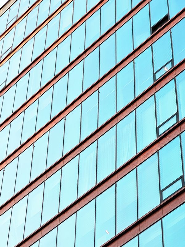 A modern building facade with blue-tinted glass windows