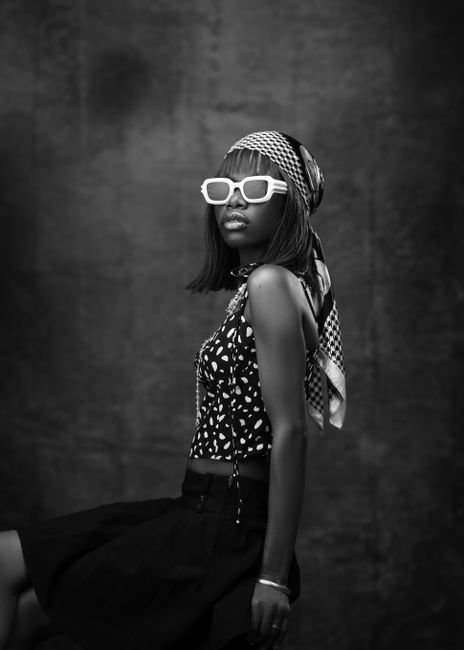 Elegant black and white portrait of a stylish woman in retro fashion.