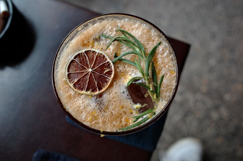 Seasonal iced coffee drink with citrus garnish at Grounded