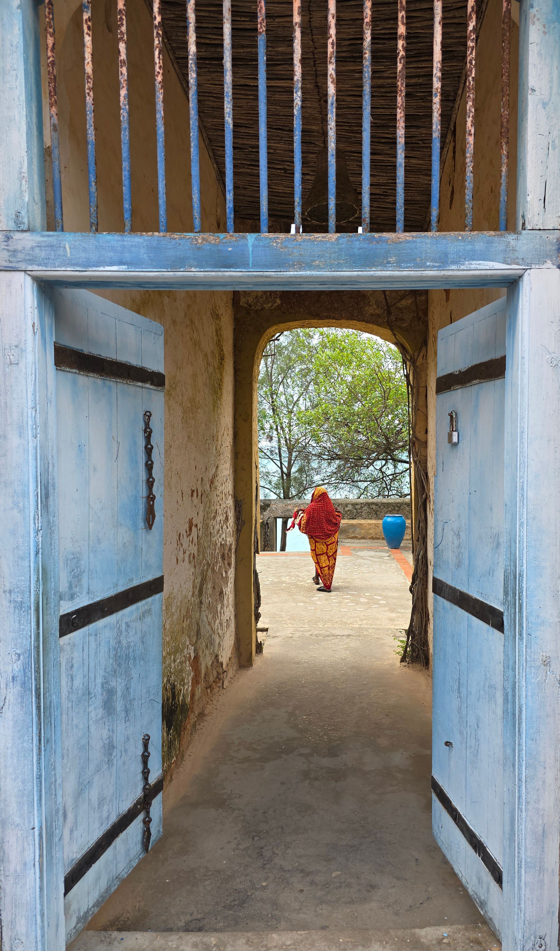 Historic Stone Town passage with blue doors in Zanzibar City.