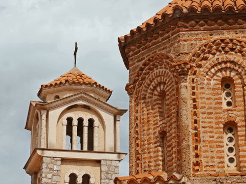 Free Close-up of Byzantine-style church with orange brick and tile roof. Stock Photo