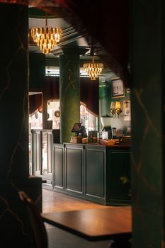 A beautifully decorated vintage café interior in Konya, showcasing elegant chandeliers and classic design.
