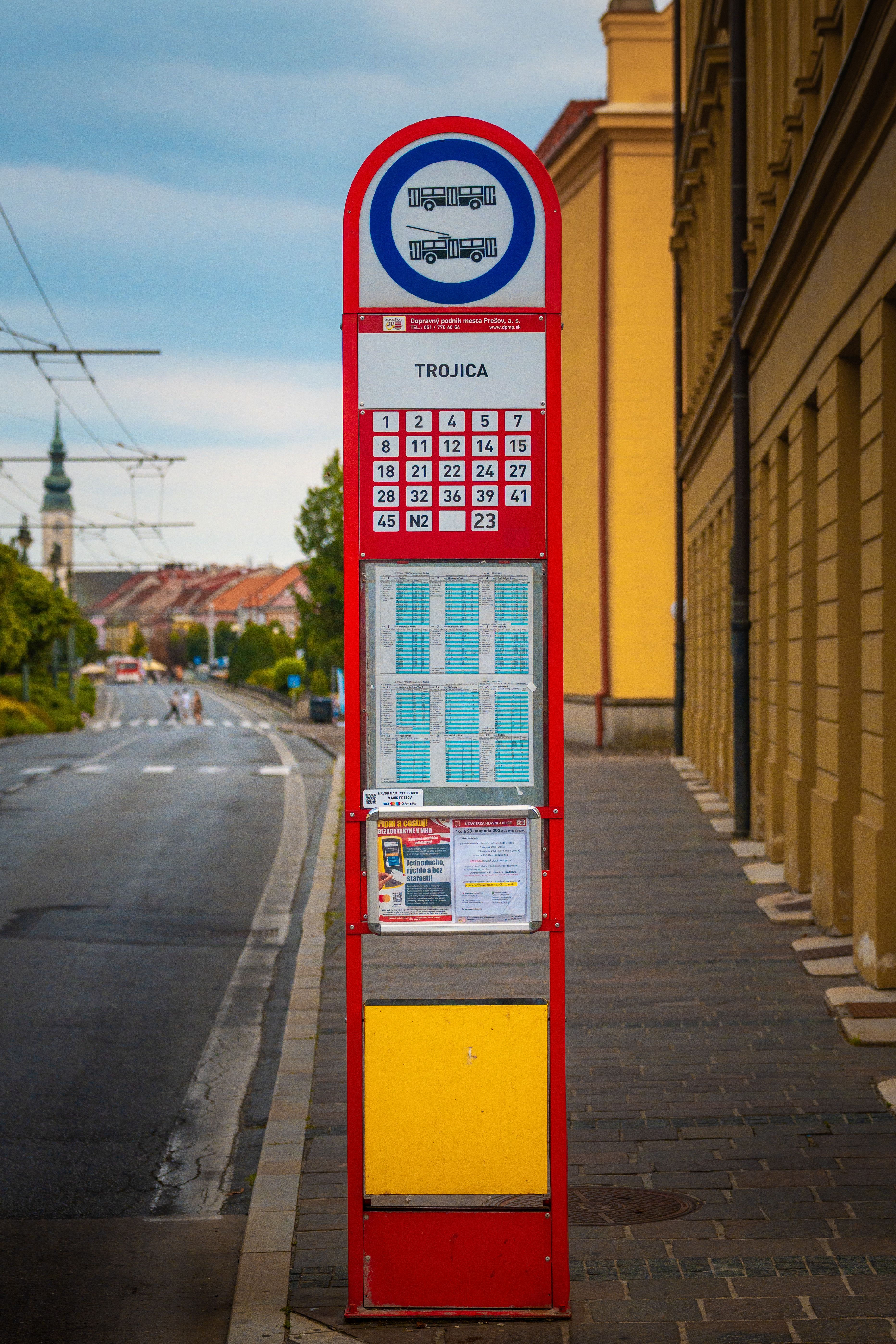 Red Bus Stop Sign in Urban Street Setting · Free Stock Photo