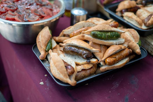 Delicious grilled sausages in bread rolls, perfect for street food lovers.
