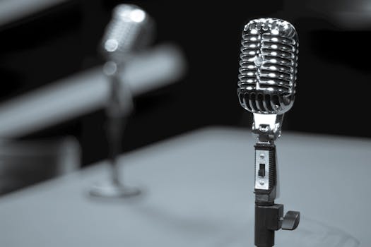 A close-up of a vintage microphone on a stand, perfect for studio recording themes.