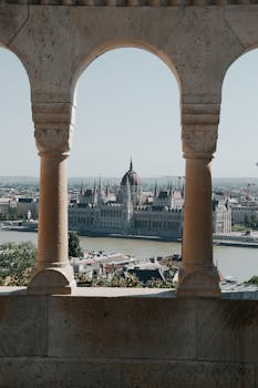Capture of Hungary's Parliament Building through arches offering a unique architectural perspective.