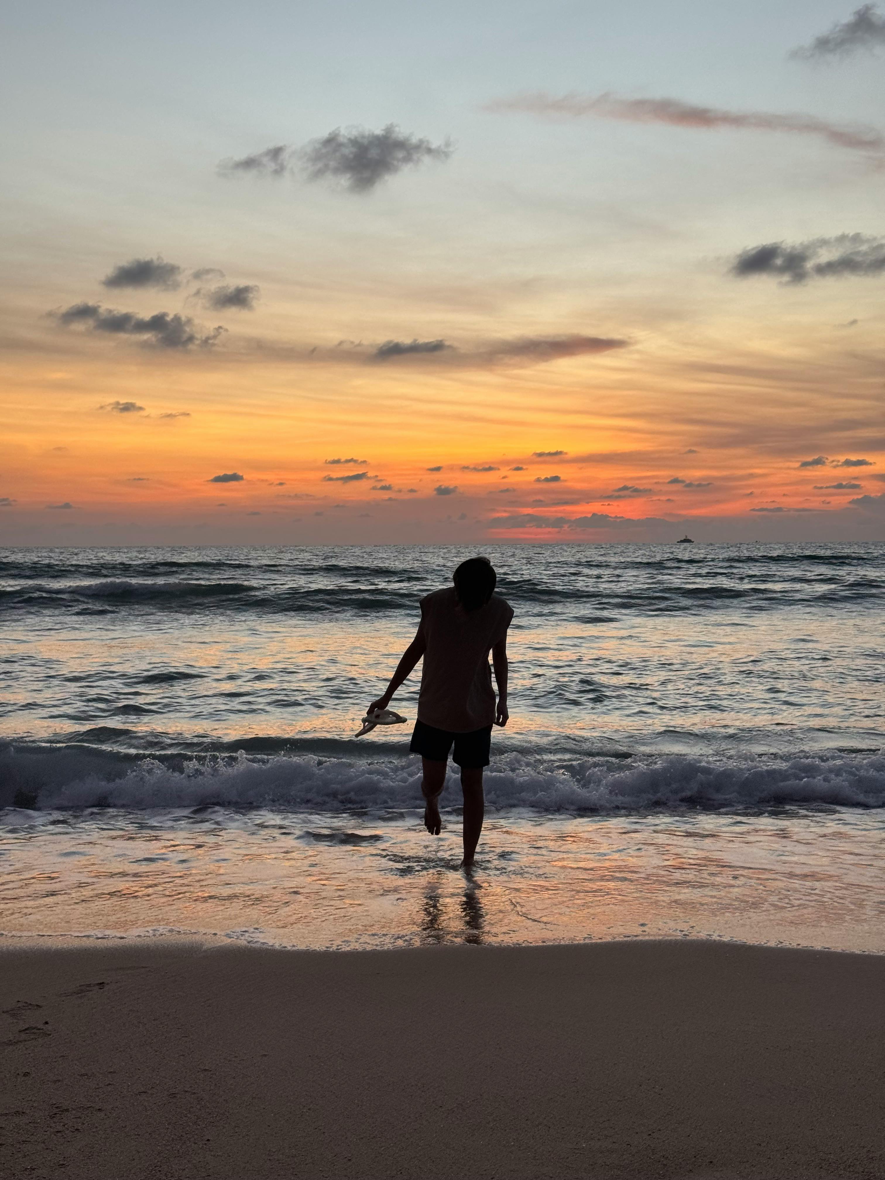 silhouette of a man at sunset on patong beach