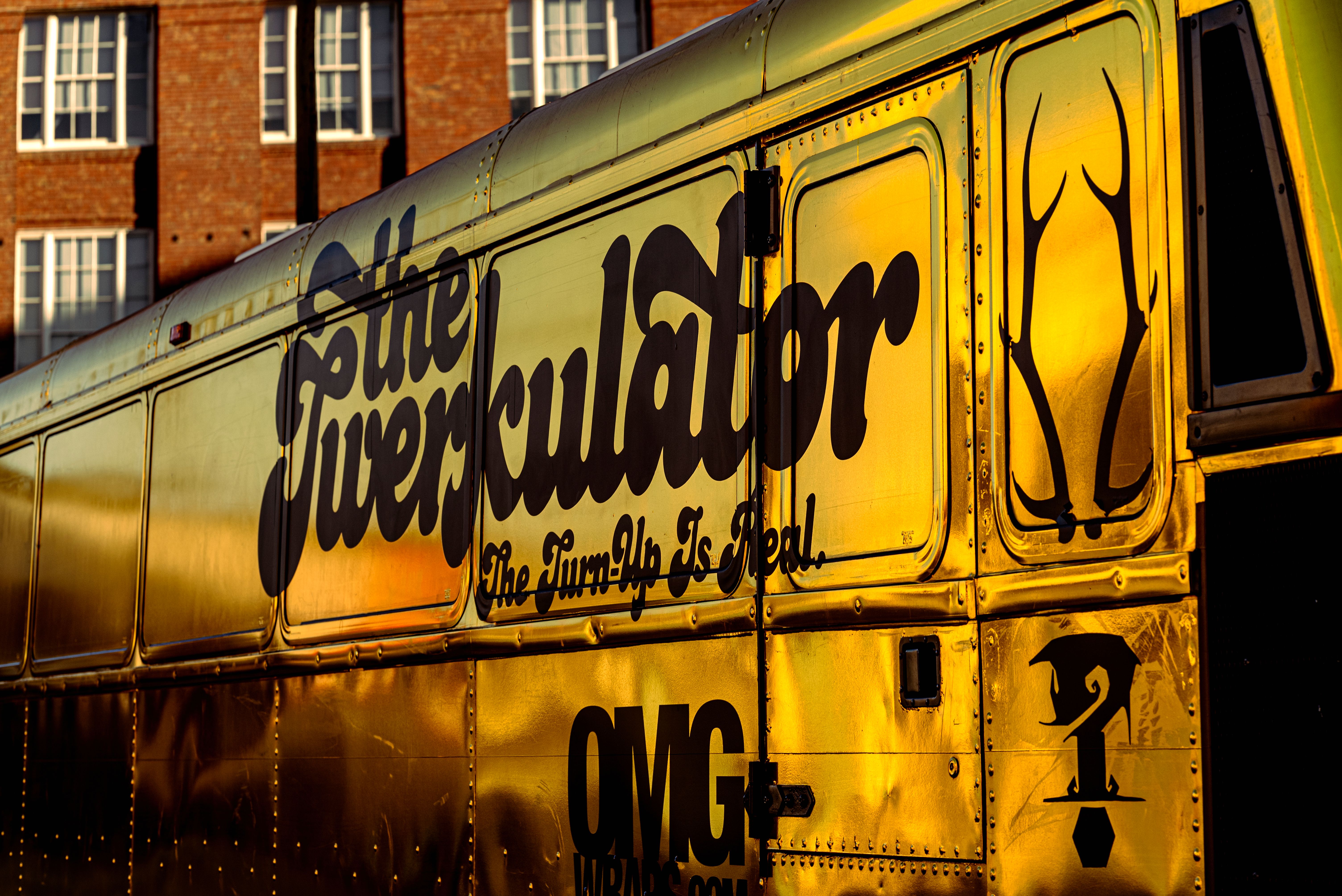Golden Party Bus with Artistic Side Design · Free Stock Photo