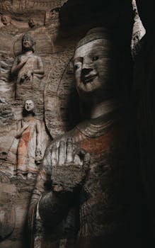 Ancient Buddhist statues at Yungang Grottoes, showcasing intricate carvings and historical artistry in Datong, China.