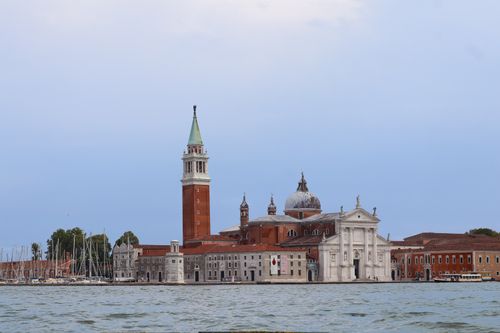 Free View of San Giorgio Maggiore Basilica across the water with clear blue sky in Venice, Italy. Stock Photo