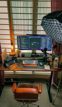 A cozy home office setup featuring dual monitors, perfect for programming and tech enthusiasts.