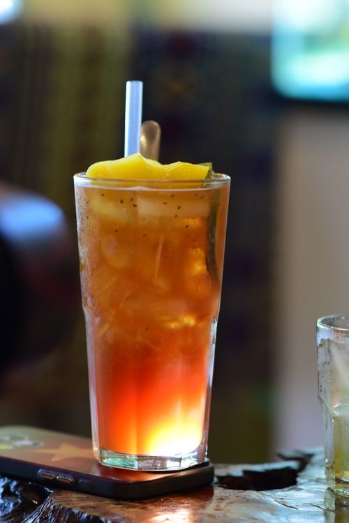 Free Tall glass of iced tea with lemon on a table, perfect for a summer day. Stock Photo