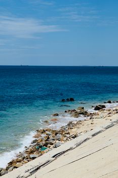 Beautiful view of a rocky beach and clear blue sea at Bình Thuận, Vietnam.