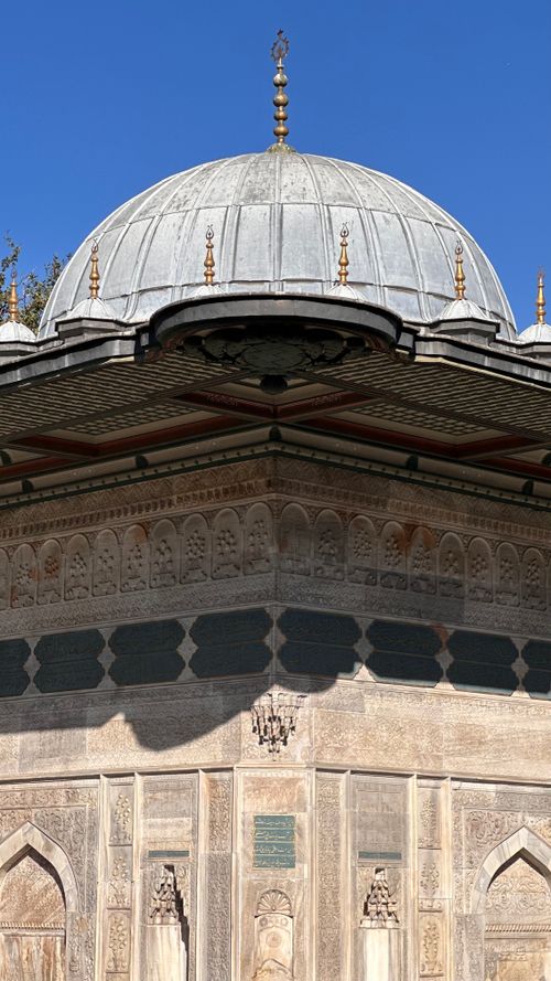 Free A detailed view of an Ottoman dome with intricate carvings under a clear blue sky. Stock Photo