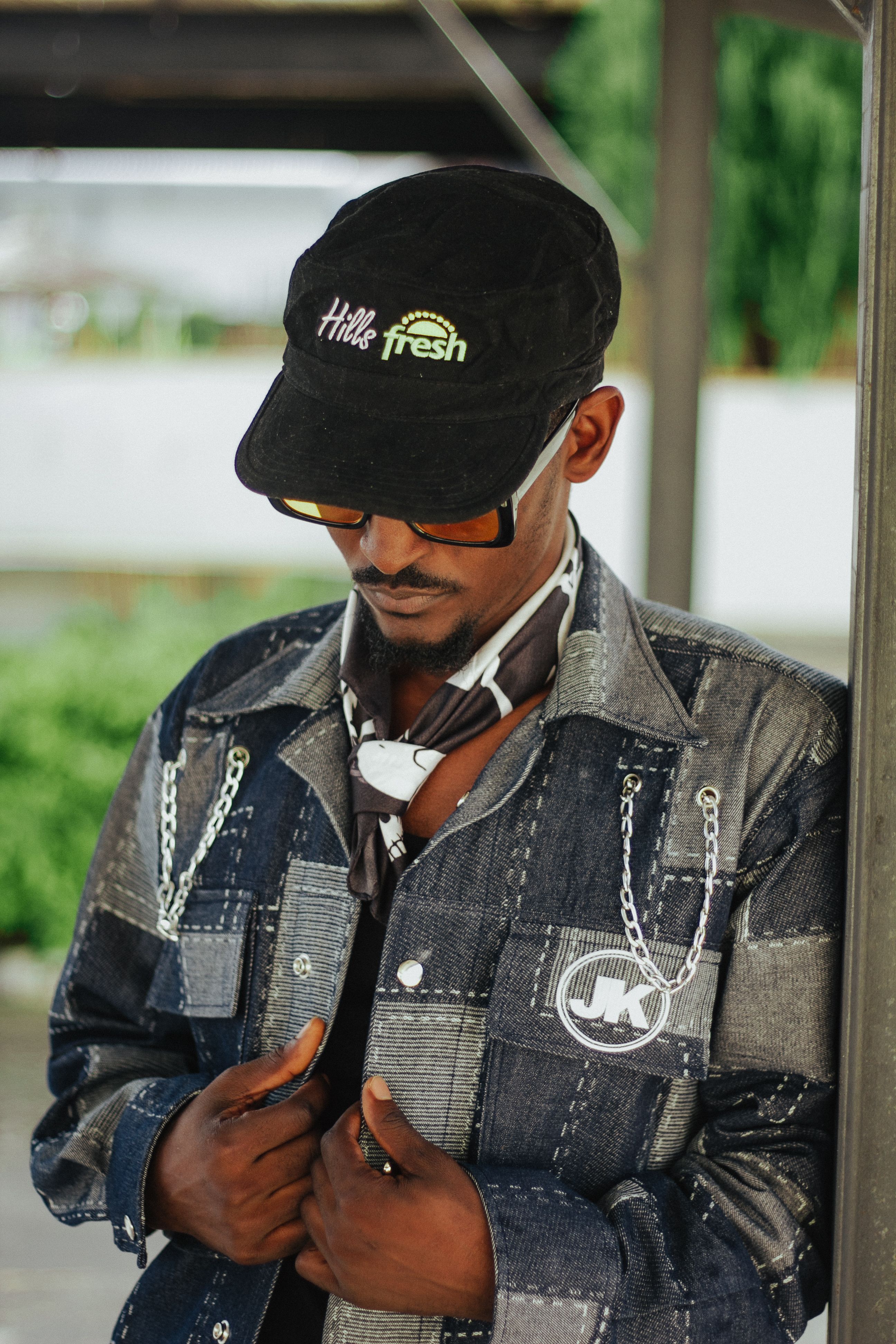 Fashion-forward man in denim with cap and sunglasses creating a modern street style.