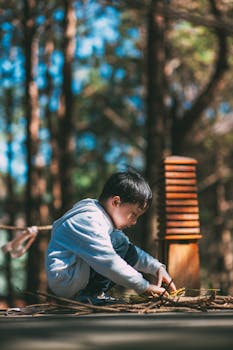 A young boy engaging with nature in a serene forest setting.