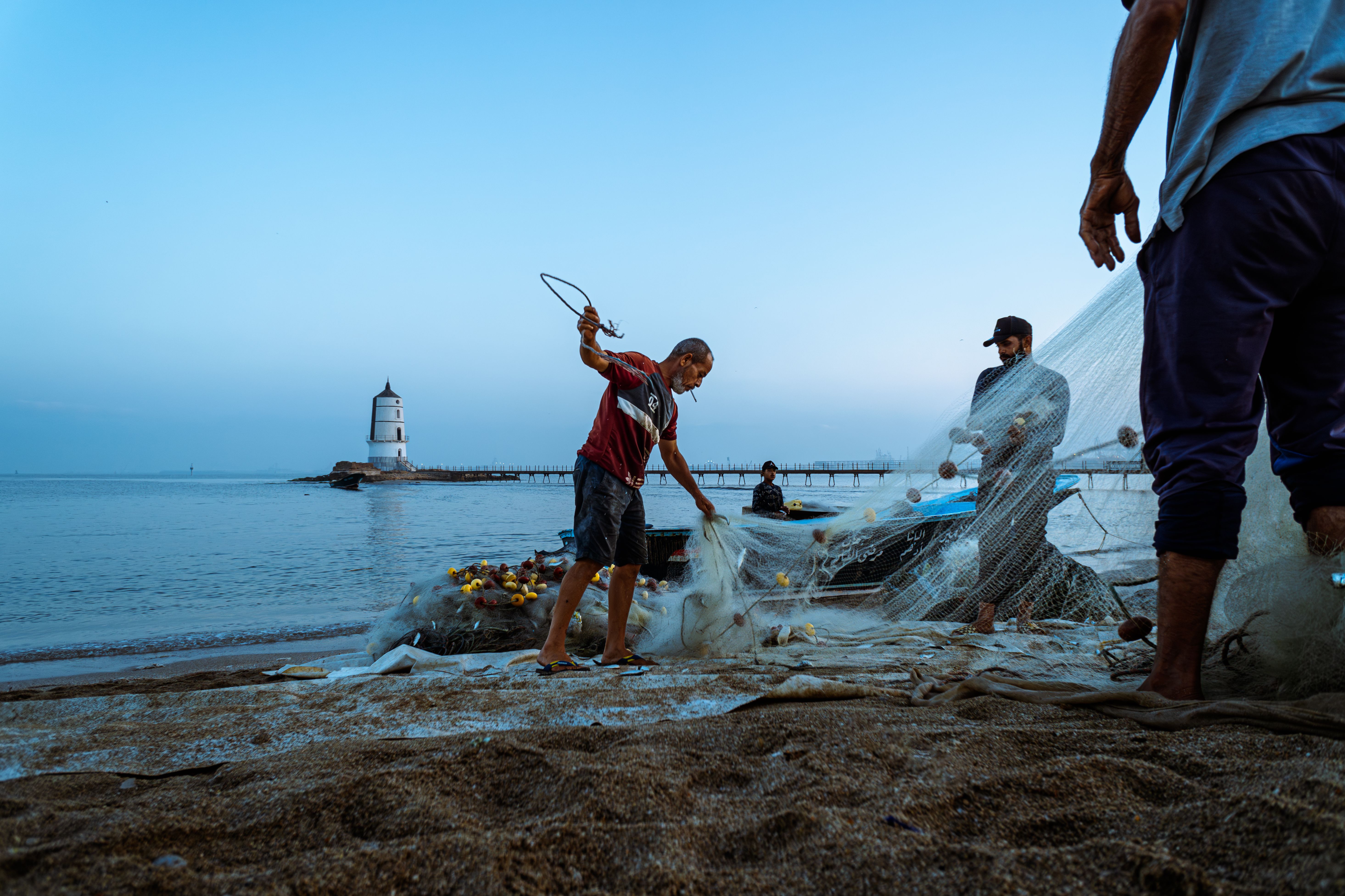 dawn of man fishing nets Fishermen at Dawn Near an Egyptian Lighthouse · Free Stock Photo