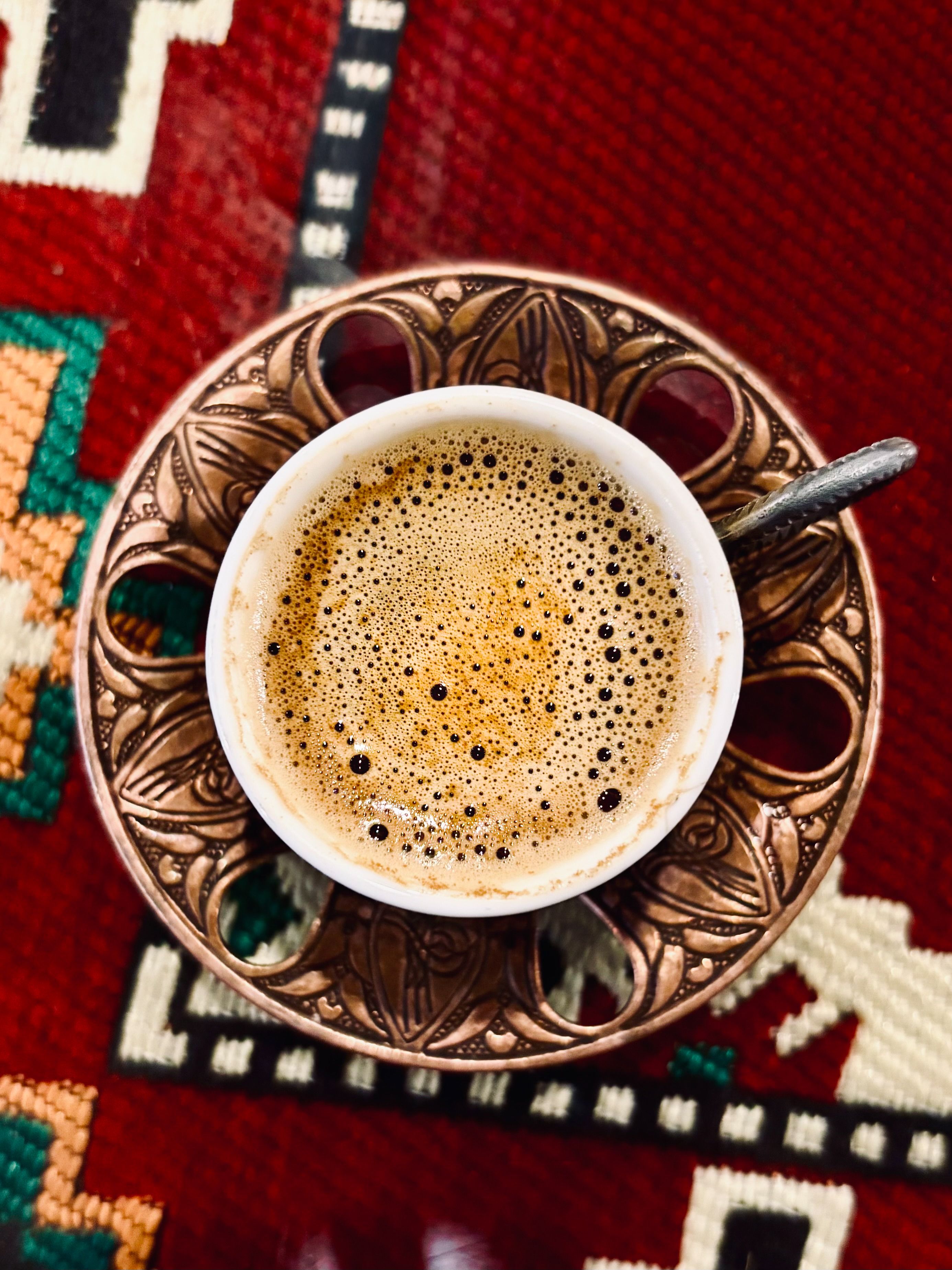 Aerial view of espresso in ornate cup on pattern  Free Stock Photo