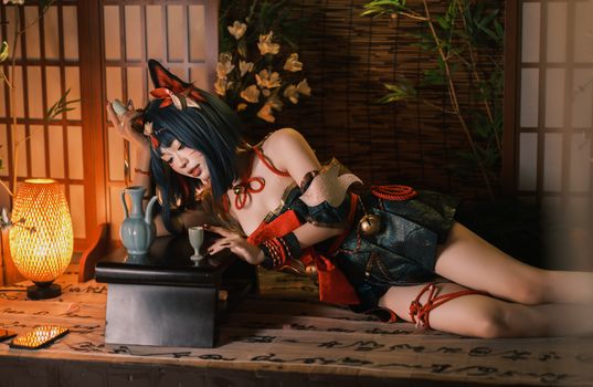 A cosplayer in traditional attire relaxes in a Japanese-inspired room.