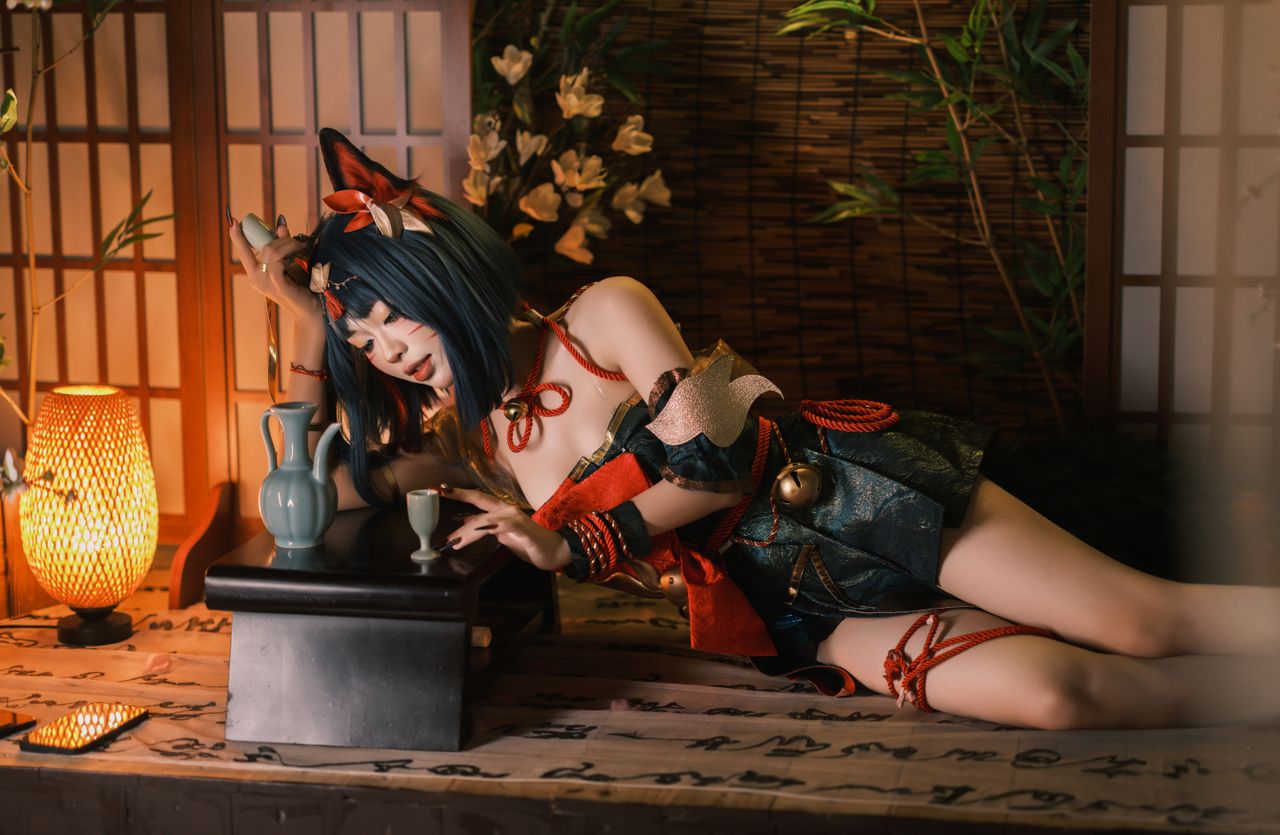 a cosplayer in traditional attire relaxes in a japanese inspired room