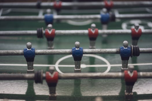 Detailed image of foosball game players on a field. Great for sports or recreational themes.