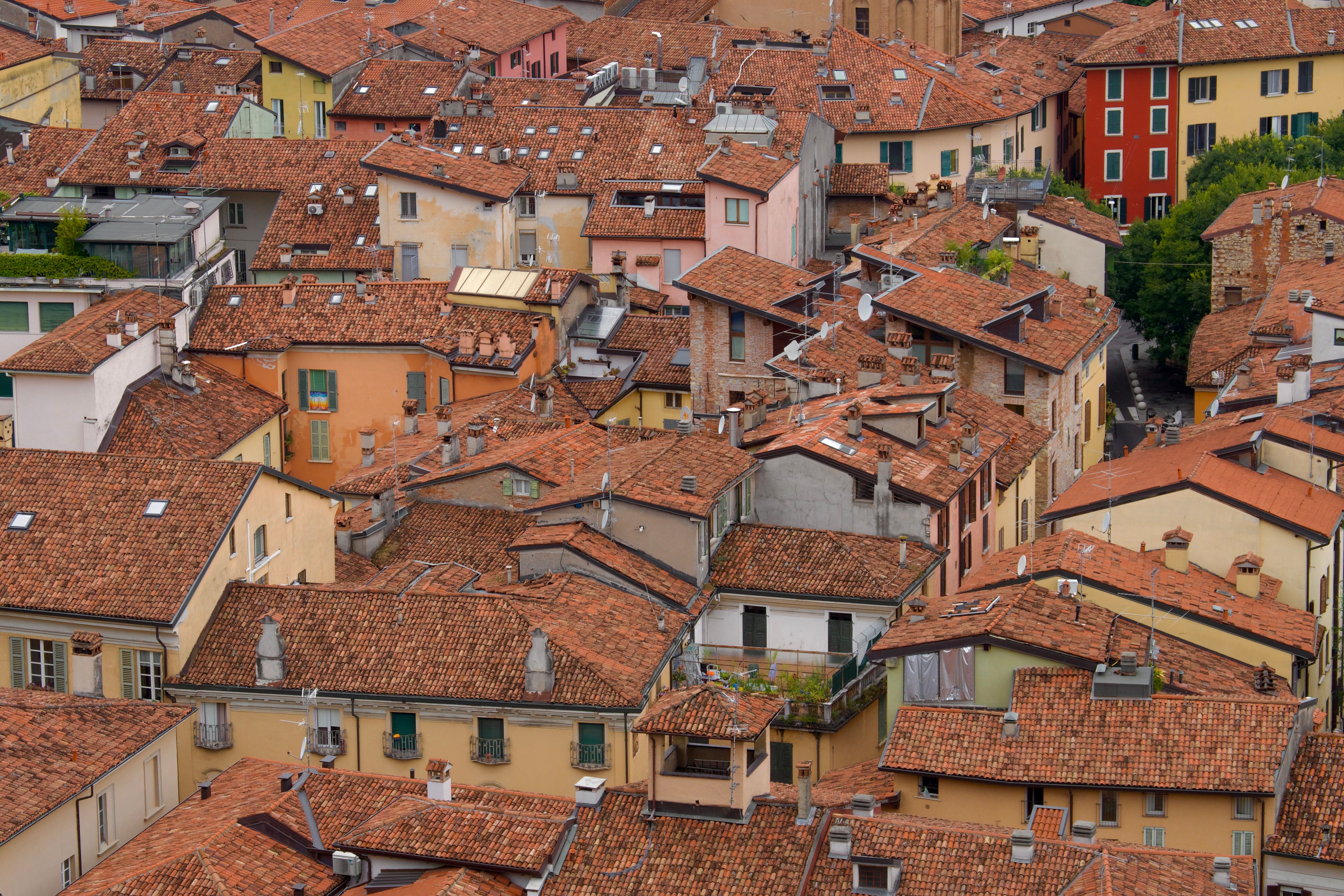 A vibrant aerial shot of traditional Italian rooftops with colorful buildings and terracotta tiles.