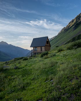 Picturesque wooden cabin in lush mountain setting, ideal for nature retreats.