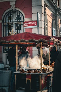 Street food vendor with chestnuts at a bustling Istanbul street.