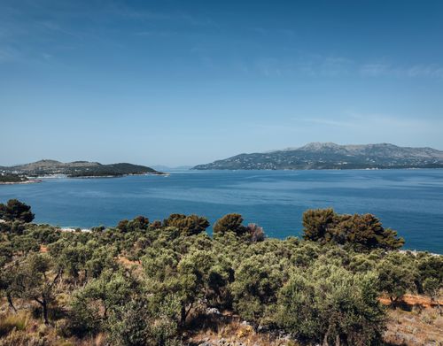 Free Breathtaking view of the Albanian coast with lush greenery and azure waters under a bright sky. Stock Photo