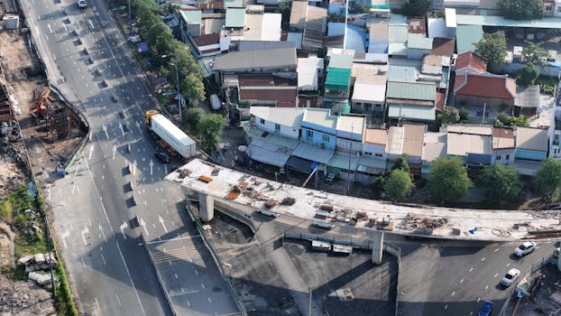Aerial view showcasing road construction and residential area in Ho Chi Minh City, Vietnam.
