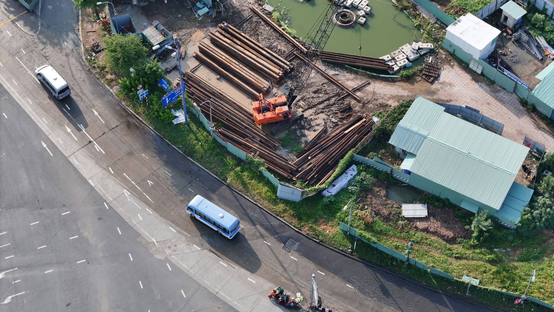 Aerial view of a bustling construction site near a busy intersection in Vietnam.