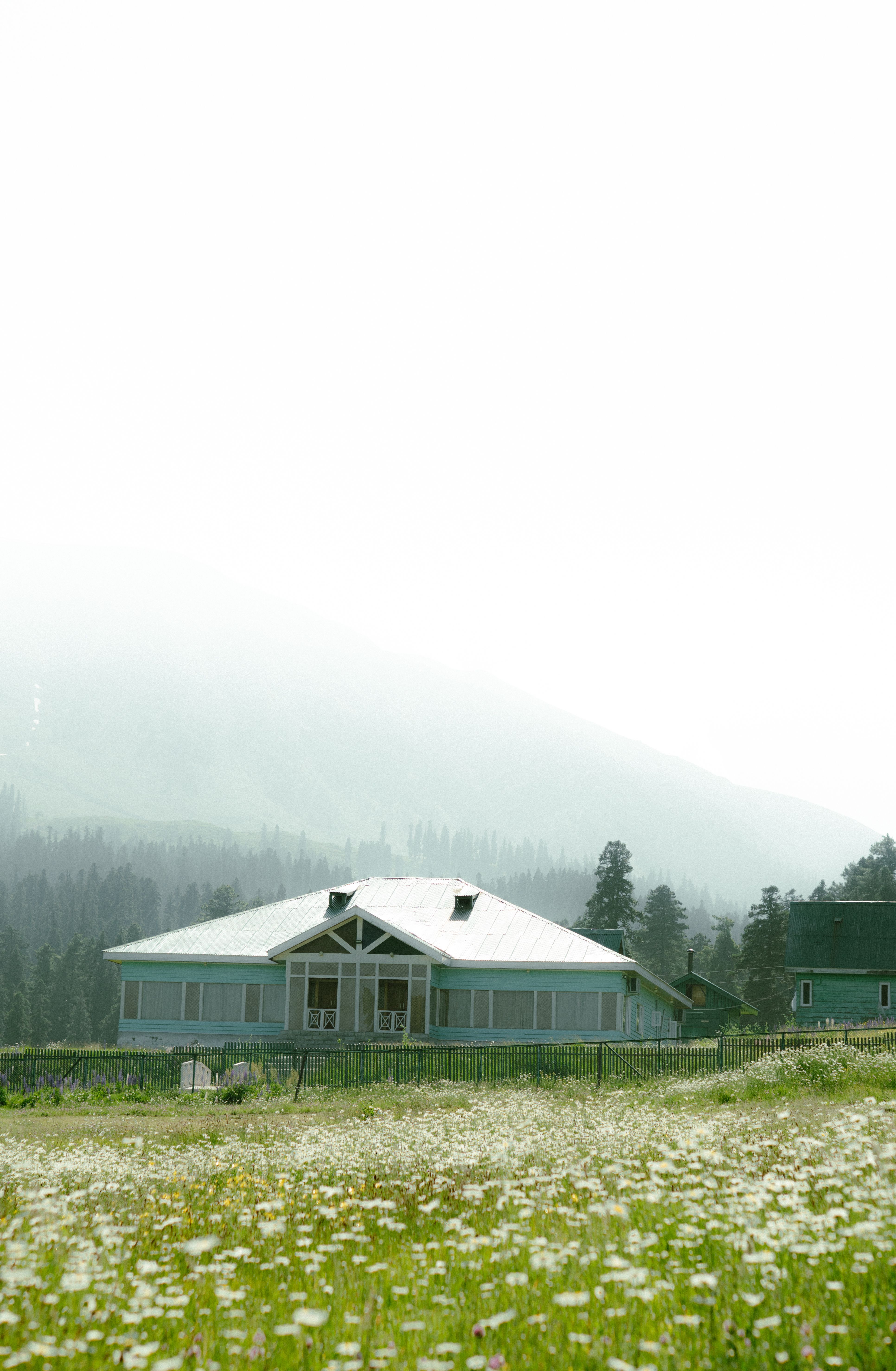 Scenic Countryside House in Misty Mountain Landscape · Free Stock Photo