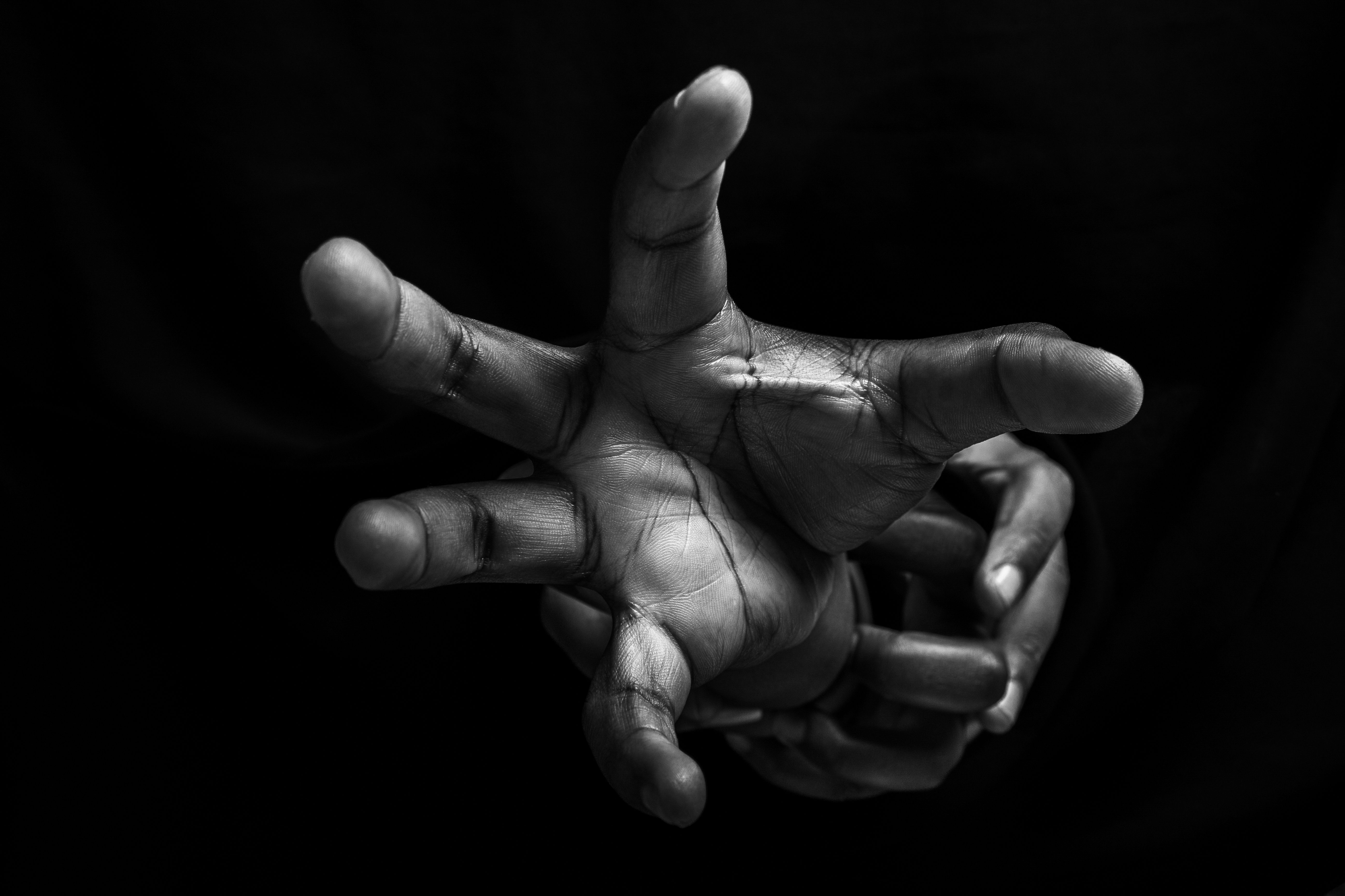 Close-Up Black and White Hands Reaching Dramatically · Free Stock Photo