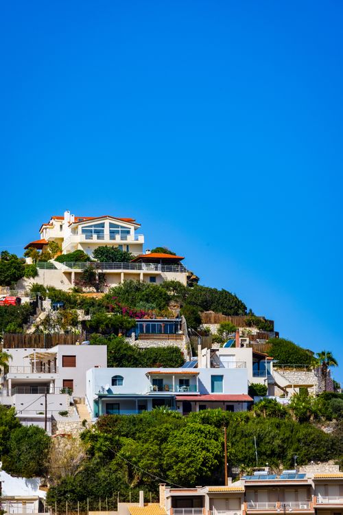 Free Scenic view of colorful villas on a cliff under a bright blue sky. Stock Photo