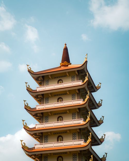 Free A stunning pagoda in Vietnam rises against a clear blue sky, showcasing traditional architecture. Stock Photo