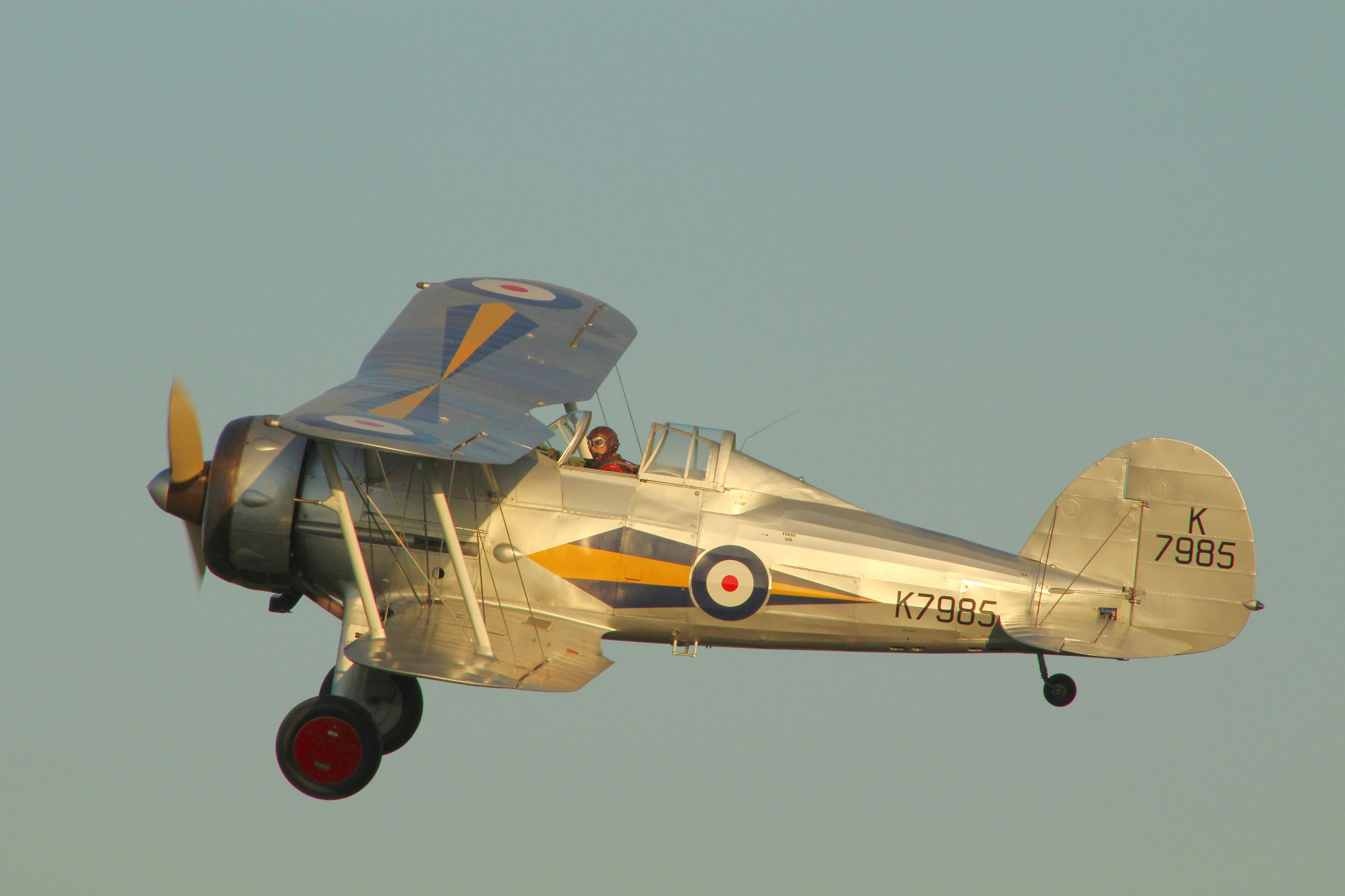 A historic biplane in flight showcasing its detailed design and markings.
