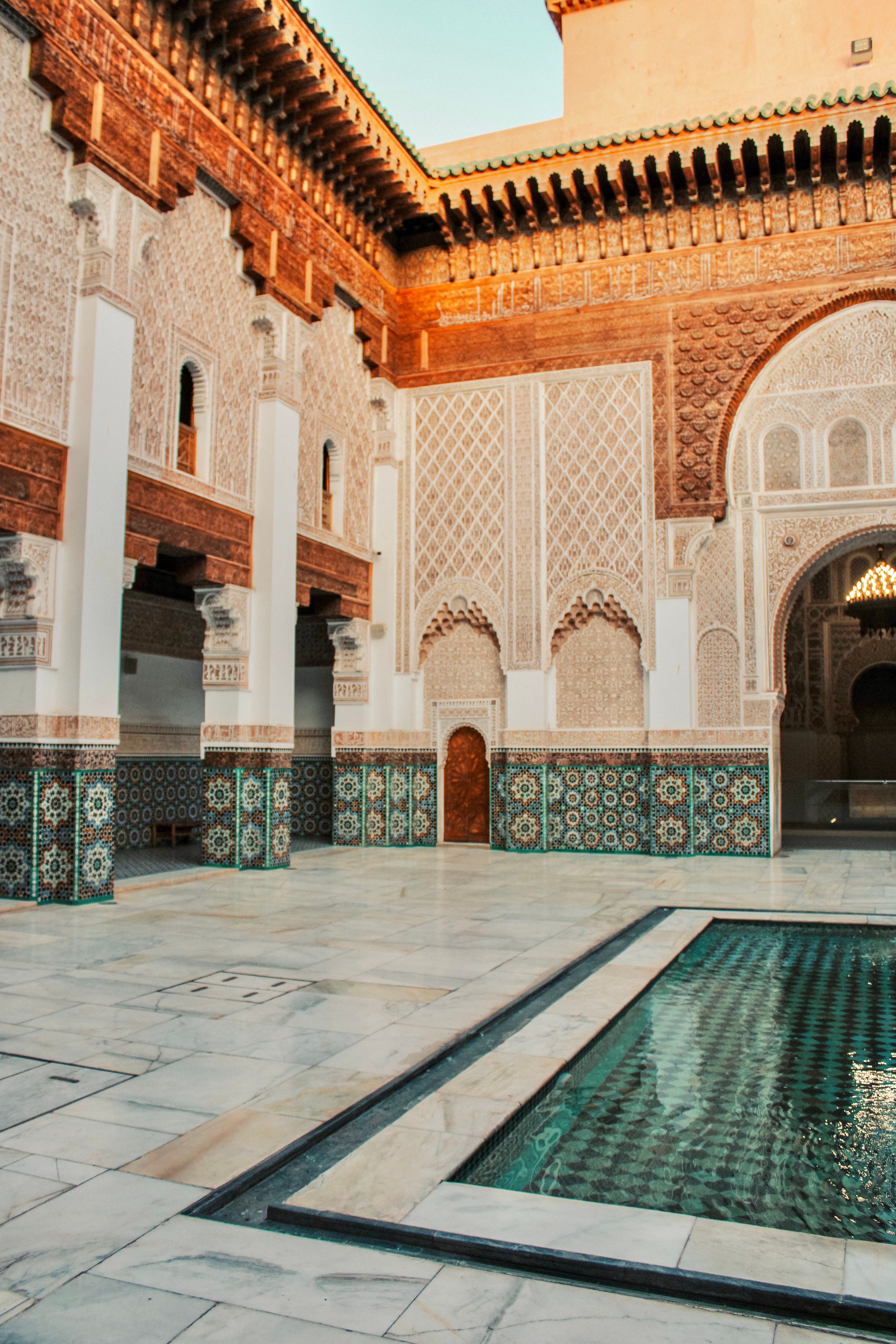 Beautiful courtyard in Marrakech showcasing intricate Islamic architecture with tilework and arches.