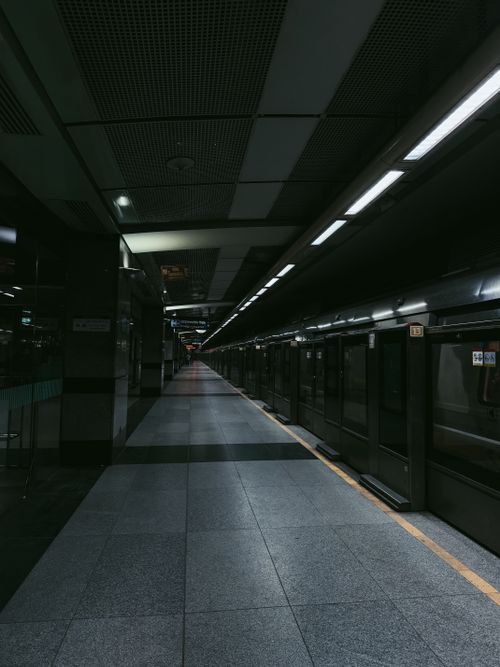 Free Dimly lit empty metro station platform at night in Delhi, India. Stock Photo