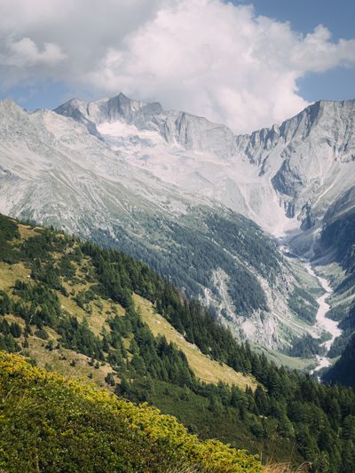 Alpine peaks over a striped valley floor — photo by merwak. raw on Pexels