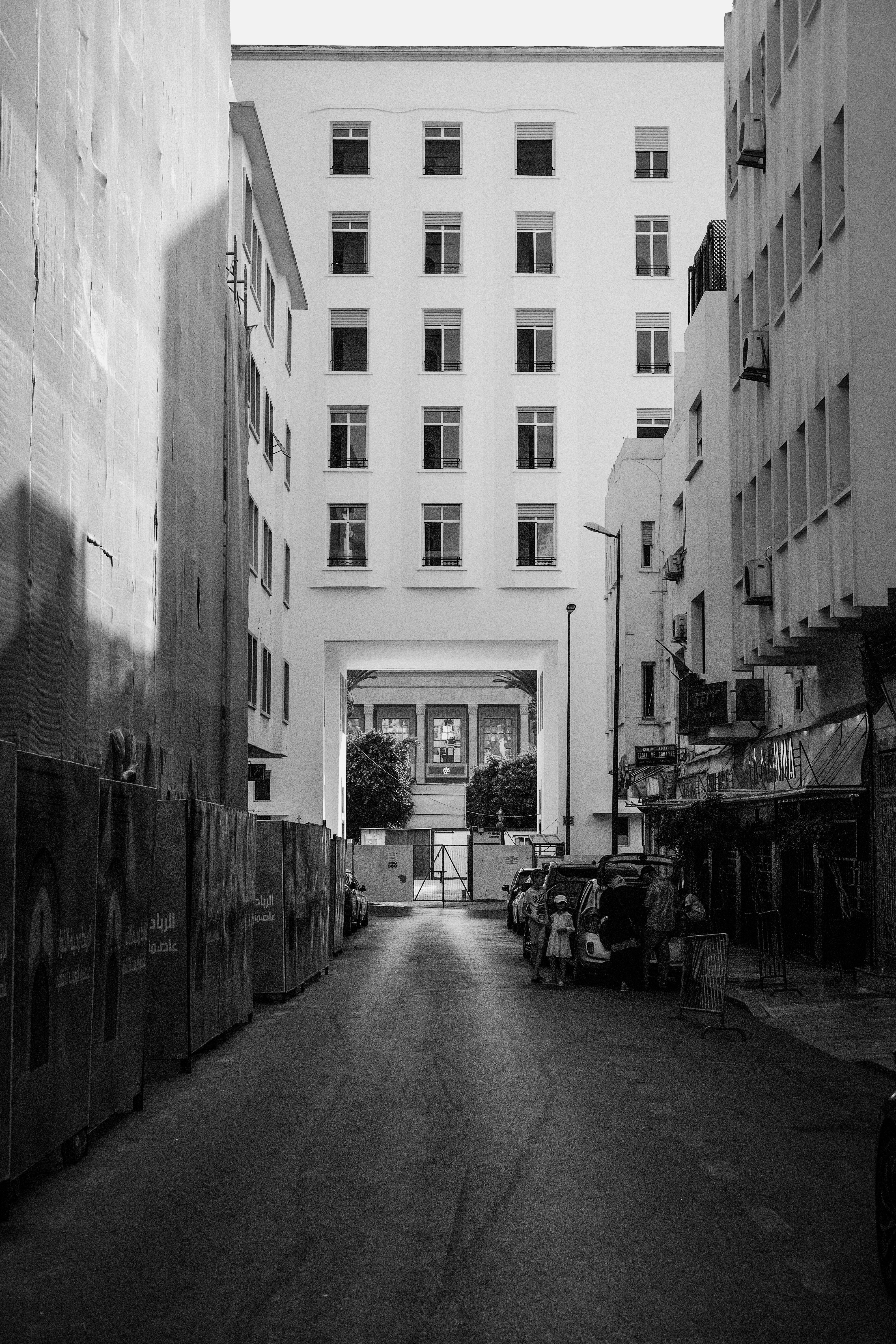 Monochrome cityscape of a narrow street in Rabat, Morocco with tall buildings.