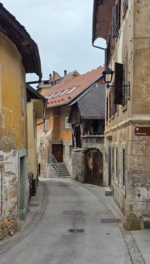 Free Explore a picturesque European alleyway showcasing rustic architecture and charming weathered facades. Stock Photo