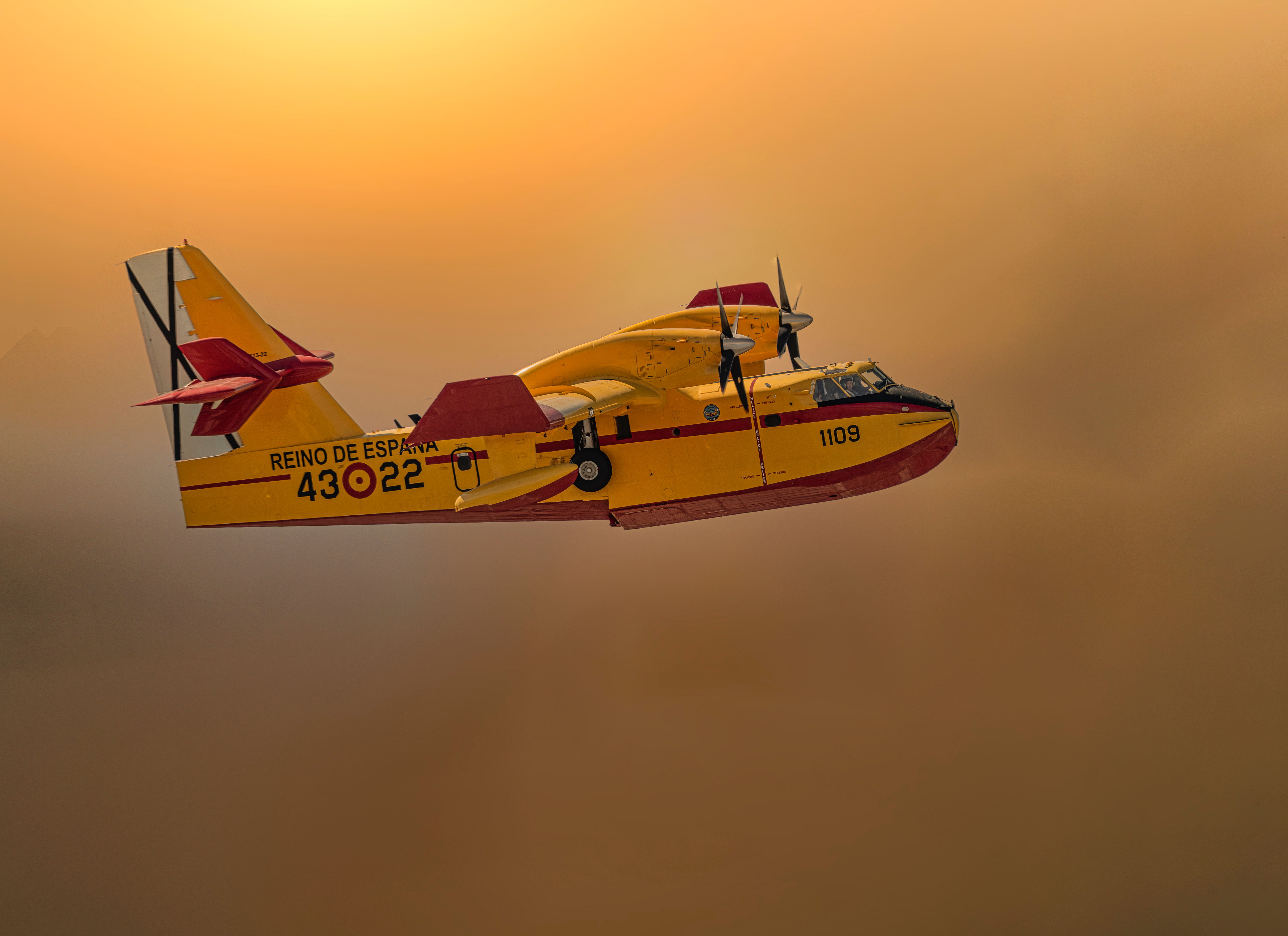 Aerial Firefighting Aircraft Flying at Sunset